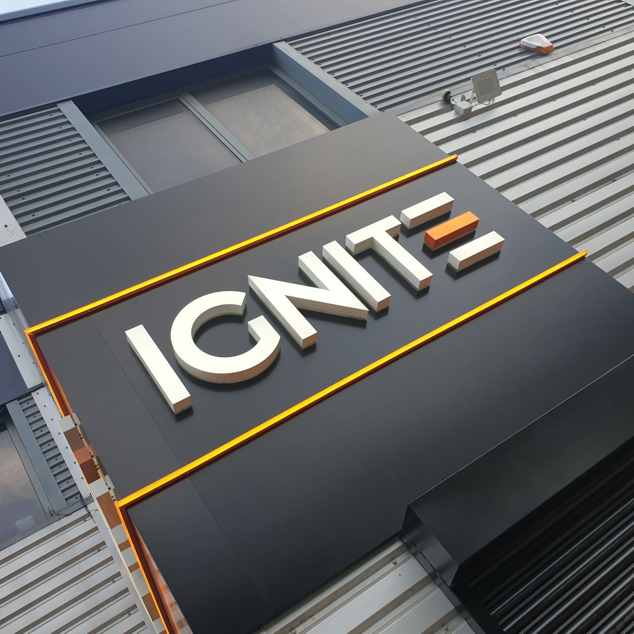 The illuminated IGNITE sign on the studio building at Orbital 25 Business Park